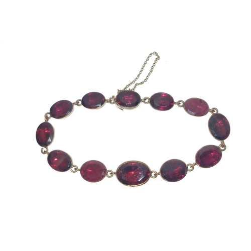 83 - VINTAGE 'yellow metal'  BRACELET set with individual 12 graduated garnets, dimension 17cm long, comp... 