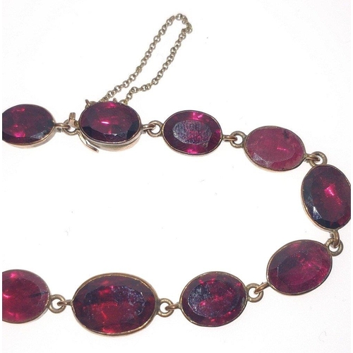 83 - VINTAGE 'yellow metal'  BRACELET set with individual 12 graduated garnets, dimension 17cm long, comp... 