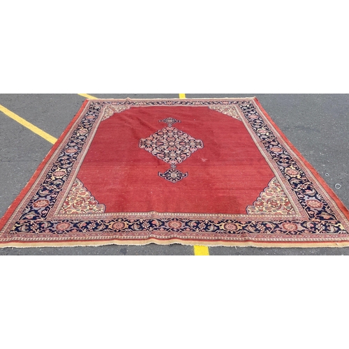 215 - An IMMENSE VINTAGE hand made CARPET FROM PAKISTAN with a terracotta background and traditional borde... 