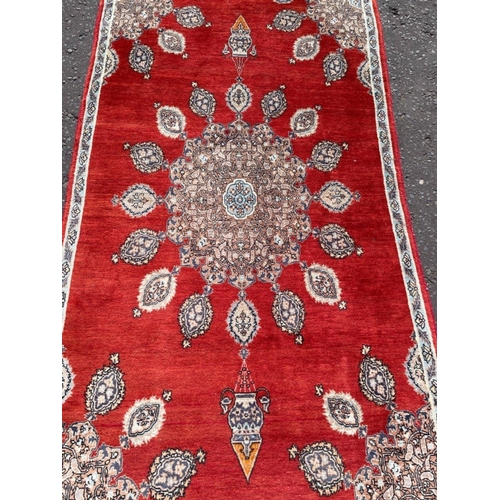 177 - An INDIAN MEDIUM SIZED red based carpet 5ft x 3ft and a quarter approx! X 3ft approx#183