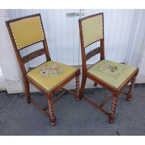 218 - A pair of vintage wooden dining chairs with handworked tapestry back panels and seats with a floral ... 