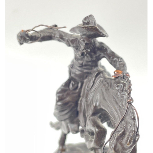 247 - Two small figurines of mounted cowboys on a marble plinth, in the style of Frederic Remington, no si... 