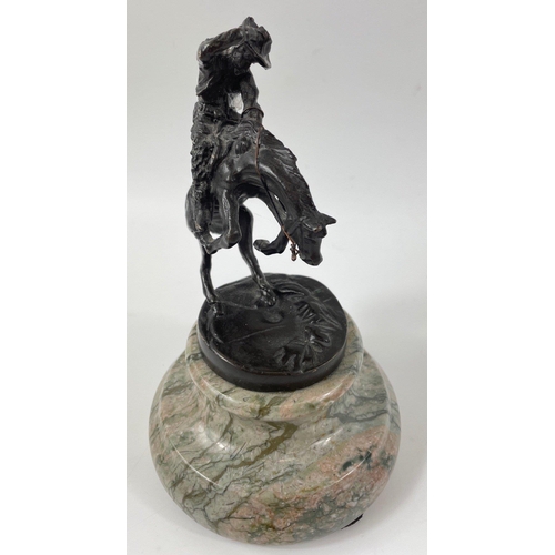 247 - Two small figurines of mounted cowboys on a marble plinth, in the style of Frederic Remington, no si... 