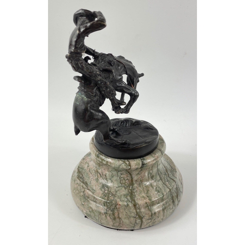 247 - Two small figurines of mounted cowboys on a marble plinth, in the style of Frederic Remington, no si... 