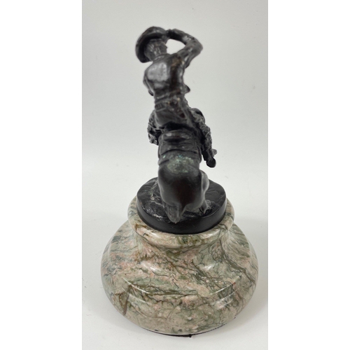 247 - Two small figurines of mounted cowboys on a marble plinth, in the style of Frederic Remington, no si... 