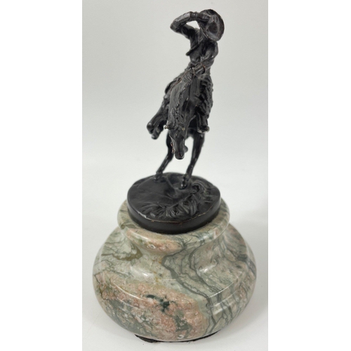 247 - Two small figurines of mounted cowboys on a marble plinth, in the style of Frederic Remington, no si... 