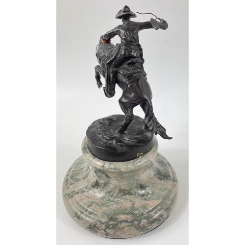 247 - Two small figurines of mounted cowboys on a marble plinth, in the style of Frederic Remington, no si... 