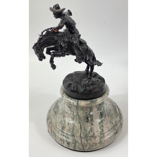 247 - Two small figurines of mounted cowboys on a marble plinth, in the style of Frederic Remington, no si... 