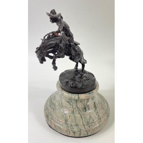 247 - Two small figurines of mounted cowboys on a marble plinth, in the style of Frederic Remington, no si... 