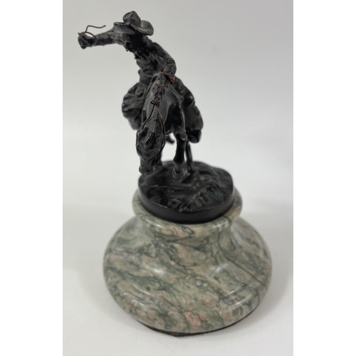 247 - Two small figurines of mounted cowboys on a marble plinth, in the style of Frederic Remington, no si... 