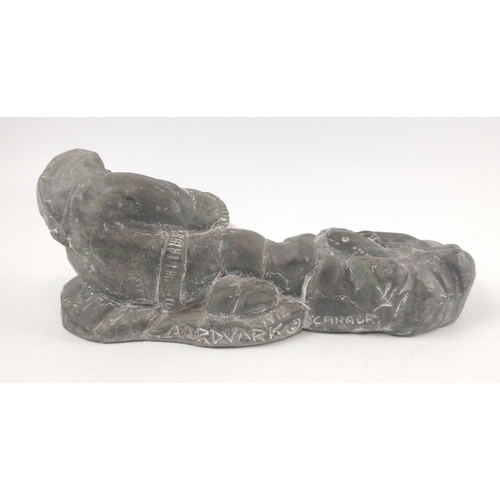 254 - A vintage Inuit soapstone carving from 1972 signed by AARDVARK of Canada of a fisherman trying to ha... 