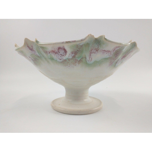 272 - A SCOTTISH STUDIO POTTERY hand painted medium sized raised bowl in pastel green white and red design... 