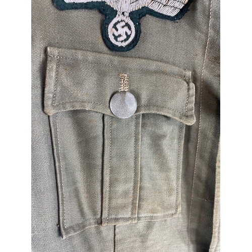 346 - RARE - A WWII German army artillery officer's summer tunic constructed of a lightweight grey cloth w... 