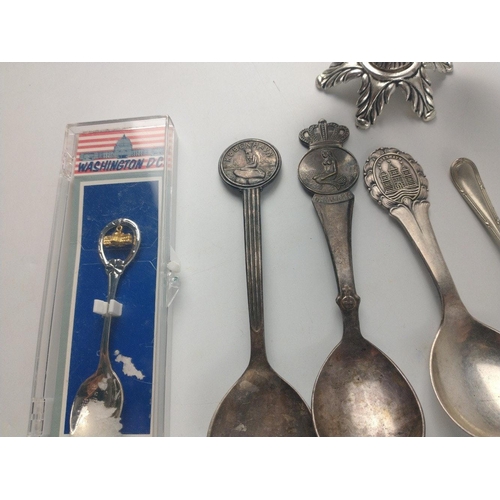 483 - A small collection of white metalware to consist of collector's spoons from around the world includi... 