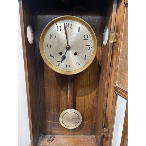 60 - A VINTAGE wooden cased wall clock with key, 78cm high#65