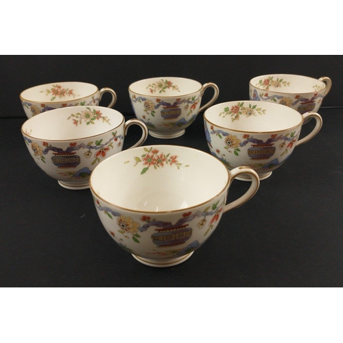 96 - A ROYAL WORCESTER tea set c 1922 to include 12 cups, 11 side plates, 2 cake plates, 12 cups and sauc... 