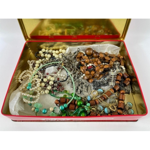 23 - A vintage KITKAT tin with a quantity of costume jewellery, mainly necklaces with a few pearl-style b... 