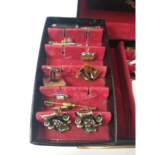 27 - A black leather jewellery case, lined with red velvet with 2 swing out sections, holding a large sel... 