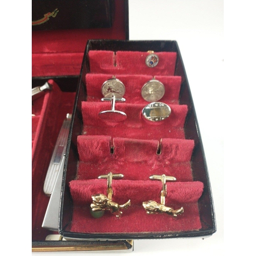 27 - A black leather jewellery case, lined with red velvet with 2 swing out sections, holding a large sel... 