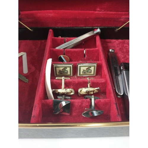 27 - A black leather jewellery case, lined with red velvet with 2 swing out sections, holding a large sel... 