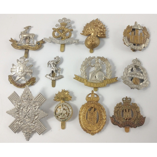 105 - Twelve British military cap badges to include THE ESSEX REGIMENT, THE FORESTERS, THE SUFFOLD REGIMEN... 