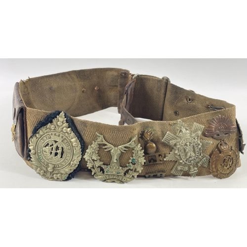 113 - A WWl belt with 15 badges and buttons including SCOTTISH HORSE, ROYAL ARMY MEDICAL CORPS, ARGYLL AND... 