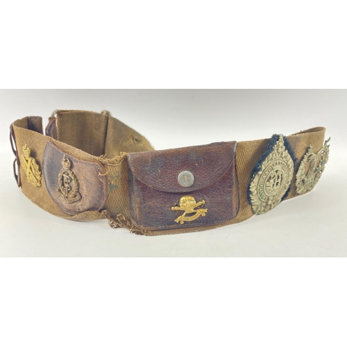 113 - A WWl belt with 15 badges and buttons including SCOTTISH HORSE, ROYAL ARMY MEDICAL CORPS, ARGYLL AND... 