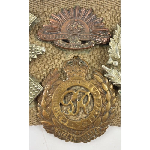 113 - A WWl belt with 15 badges and buttons including SCOTTISH HORSE, ROYAL ARMY MEDICAL CORPS, ARGYLL AND... 