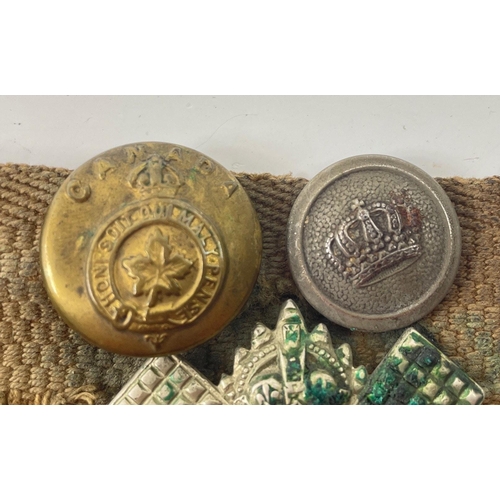 113 - A WWl belt with 15 badges and buttons including SCOTTISH HORSE, ROYAL ARMY MEDICAL CORPS, ARGYLL AND... 