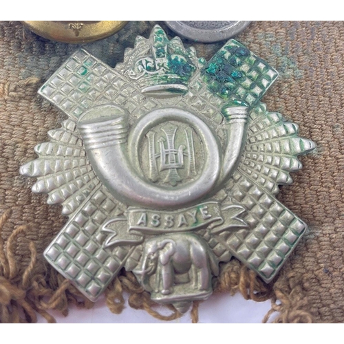 113 - A WWl belt with 15 badges and buttons including SCOTTISH HORSE, ROYAL ARMY MEDICAL CORPS, ARGYLL AND... 