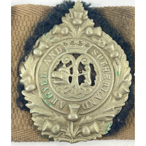 113 - A WWl belt with 15 badges and buttons including SCOTTISH HORSE, ROYAL ARMY MEDICAL CORPS, ARGYLL AND... 