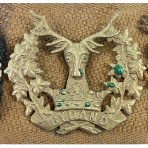 113 - A WWl belt with 15 badges and buttons including SCOTTISH HORSE, ROYAL ARMY MEDICAL CORPS, ARGYLL AND... 