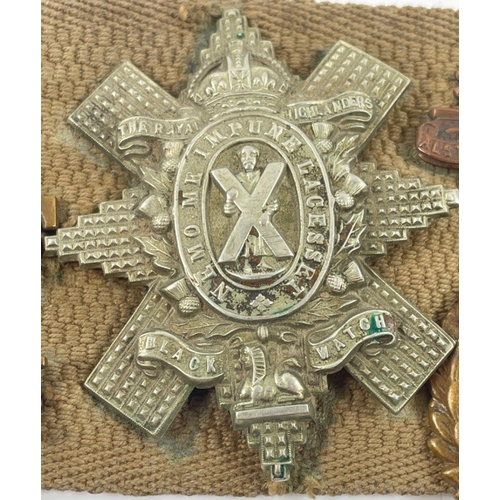 113 - A WWl belt with 15 badges and buttons including SCOTTISH HORSE, ROYAL ARMY MEDICAL CORPS, ARGYLL AND... 