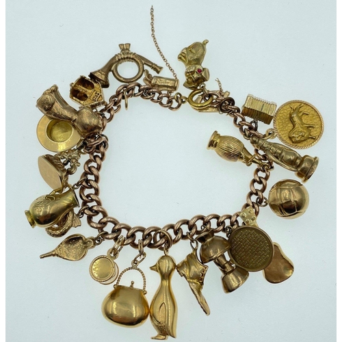 12 - LOTS OF CHARMS!A 375 stamped gold charm bracelet , the 375 is partially rubbed, with most charms sta... 