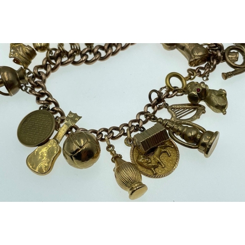 12 - LOTS OF CHARMS!A 375 stamped gold charm bracelet , the 375 is partially rubbed, with most charms sta... 