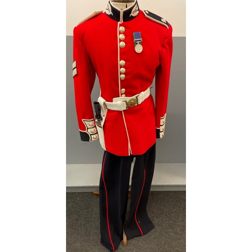 120 - A SCOTS GUARDS CEREMONIAL UNIFORM comprising a bearskin and brass-decorated chinstrap, a red tunic (... 