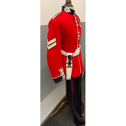 120 - A SCOTS GUARDS CEREMONIAL UNIFORM comprising a bearskin and brass-decorated chinstrap, a red tunic (... 