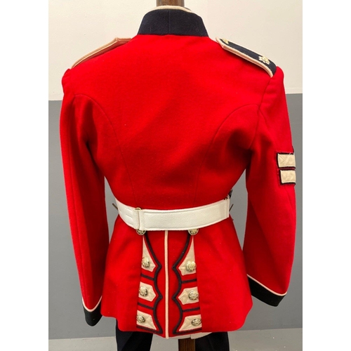 120 - A SCOTS GUARDS CEREMONIAL UNIFORM comprising a bearskin and brass-decorated chinstrap, a red tunic (... 