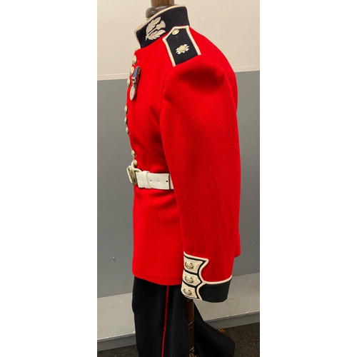 120 - A SCOTS GUARDS CEREMONIAL UNIFORM comprising a bearskin and brass-decorated chinstrap, a red tunic (... 