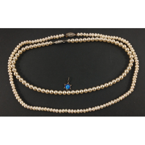 24 - TWO STRINGS OF REAL PEARLSA nice string of real PEARLS with white metal clasp with three small white... 