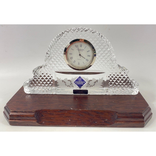 72 - EDINBURGH CRYSTAL - a small glass mantle clock complete with plinth - dimensions 15cm length x 9cm h... 