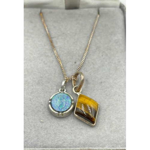 9 - Two silver pendants - a tiger's eye and an opal on a silver chain 44cm long  gross weight 4.7gm#10... 