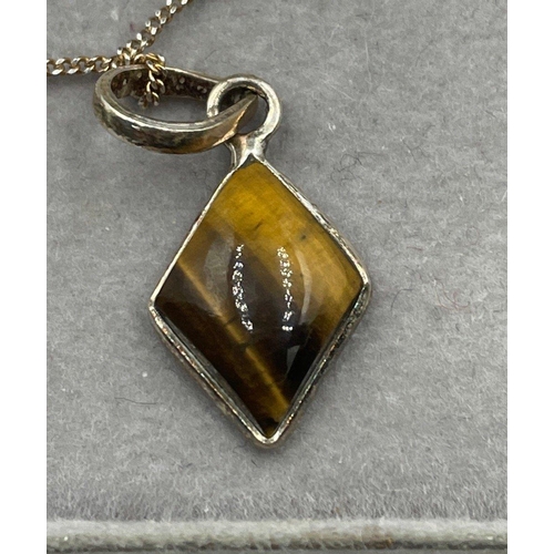 9 - Two silver pendants - a tiger's eye and an opal on a silver chain 44cm long  gross weight 4.7gm#10... 