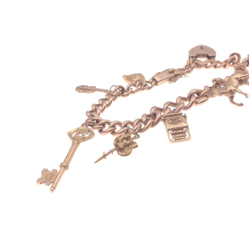 33 - A gold 375 charm bracelet with 7 charms, six of which are stamped 375, bracelet length approx 18cm, ... 