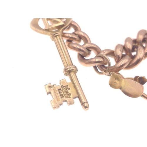 33 - A gold 375 charm bracelet with 7 charms, six of which are stamped 375, bracelet length approx 18cm, ... 