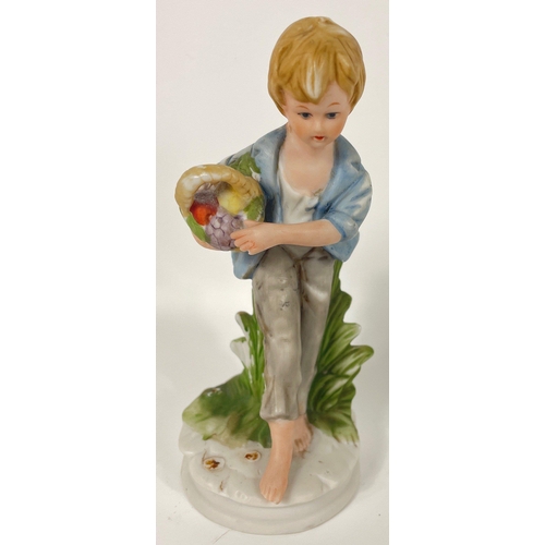 148 - A pair of VINTAGE CAPO DI MONTE style boy and girl figurines both carrying baskets, the girl has a l... 