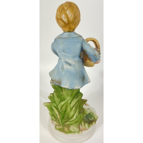 148 - A pair of VINTAGE CAPO DI MONTE style boy and girl figurines both carrying baskets, the girl has a l... 