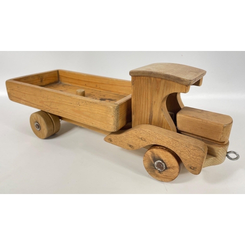 156 - A real treat for lovers of wooden hand-crafted items - a pull along vintage car (22x18cm), a tractor... 