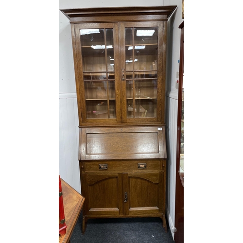 277A - A circa 1930's oak antique library and fitted bureau cabinet, with two glazed doors and four shelves... 