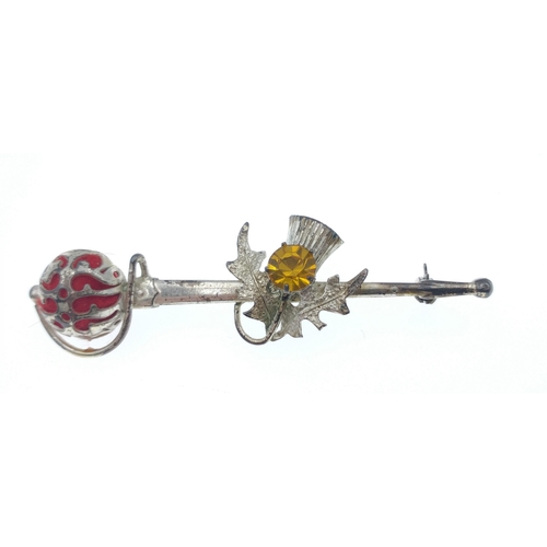 32 - A vintage Scottish brooch stamped 925, in the shape of a claymore with a thistle supporting a yellow... 